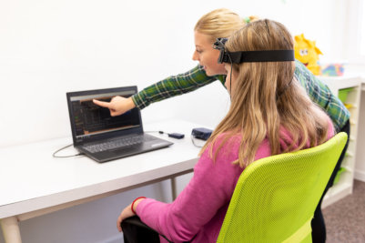 therapists assisting young woman biofeedback therapy
