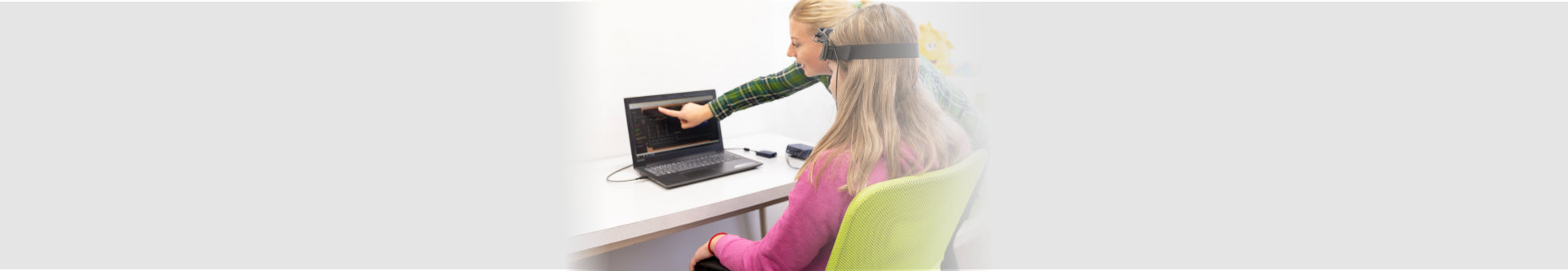 therapists assisting young woman biofeedback therapy
